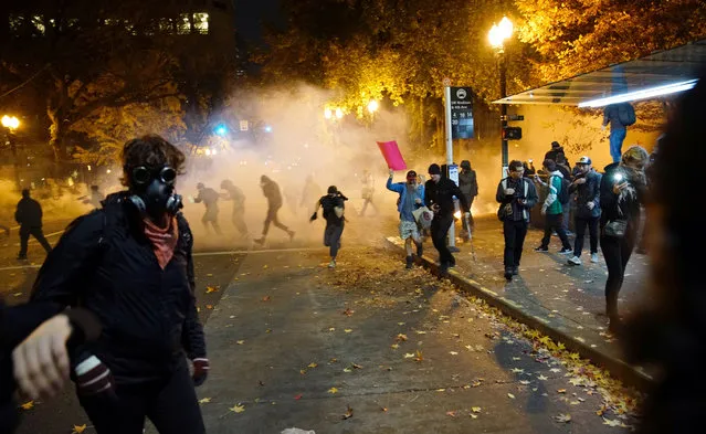 People try to move away from a gas cloud during a protest against the election of Republican Donald Trump as President of the United States in Portland, Oregon, U.S. November 12, 2016. (Photo by William Gagan/Reuters)