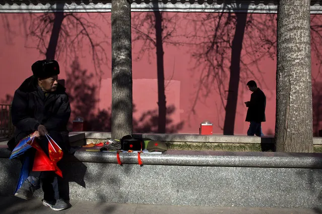 A vendor selling national flags and other memorabilia during a sunny day in Beijing Friday, December 18, 2015. (Photo by Ng Han Guan/AP Photo)