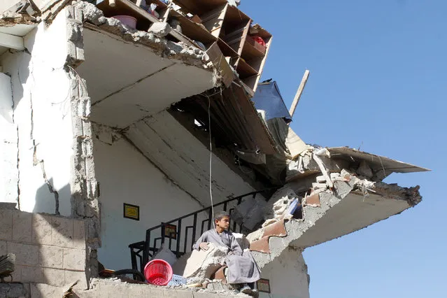 A boy sits on the wreckage of a house destroyed by a Saudi-led air strike on the outskirts of Sanaa, Yemen, November 13, 2016. (Photo by Mohamed al-Sayaghi/Reuters)