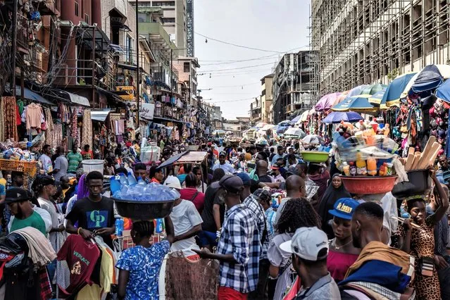 Shoppers and traders in a congested street market in Lagos, Nigeria, on Monday, July 17, 2023. Nigeria's monthly inflation rate soared to a seven-year high in June, after President Bola Tinubu scrapped fuel subsidies and allowed the currency to weaken before declaring a state of emergency to control staple food costs. (Photo by Benson Ibeabuchi/Bloomberg)