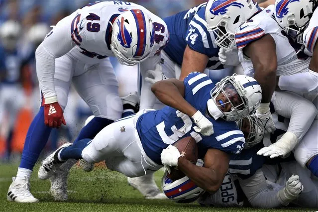 Indianapolis Colts running back Kenyan Drake, bottom, dives forward against the Buffalo Bills during the second half of an NFL preseason football game in Orchard Park, N.Y., Saturday, August 12, 2023. (Photo by Adrian Kraus/AP Photo)