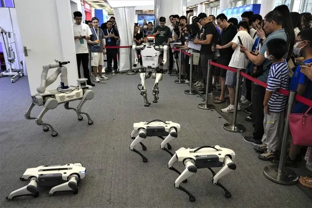 Visitors look at the remote control robots perform during the annual World Robot Conference at the Etrong International Exhibition and Convention Center on the outskirts of Beijing, Thursday, August 17, 2023. (Photo by Andy Wong/AP Photo)