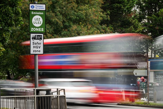 Vehicles pass by a sign indicating the new boundary of the LEZ and ULEZ expansion on August 29, 2023 in London, England. August 29 is the first day of the London-wide Ultra Low Emission Zone (ULEZ) expansion to all of Greater London, a policy designed to reduce air pollution by imposing charges on drivers of older, more polluting vehicles. The new rules have sparked political backlash in some parts of London and neighbouring counties. (Photo by Leon Neal/Getty Images)