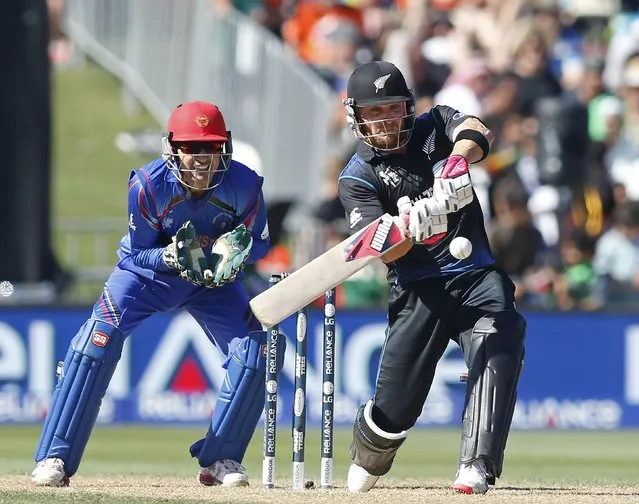 New Zealand's Brendon McCullum hits a six watched by Afghanistan's Afsar Zazai during their Cricket World Cup match in Napier, March 8, 2015. REUTERS/Nigel Marple (NEW ZEALAND - Tags: SPORT CRICKET)