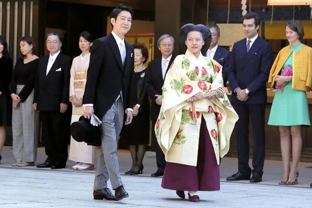 Japanese Princess Ayako, center right, dressed in traditional ceremonial robe, and groom Kei Moriya, center left, arrive at Meiji Shrine for their wedding ceremony in Tokyo, Monday, October 29, 2018. Japan's Princess Ayako married Moriya, a commoner in a ritual-filled ceremony Monday at Tokyo's Meiji Shrine. (Photo by Kyodo News via AP Photo)