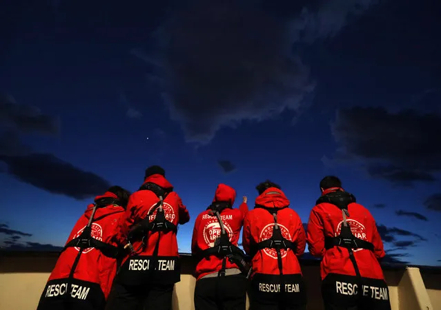 Lifeguards of the Spanish NGO Proactiva Open Arms stand on the stern of the former fishing trawler Golfo Azzurro as the vessel departs from the port of Malta to conduct search and rescue operations for migrants off the Libyan coast in central Mediterranean Sea December 30, 2016. (Photo by Yannis Behrakis/Reuters)