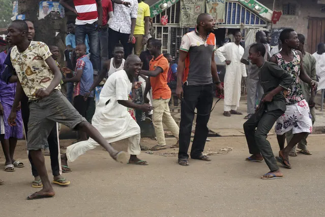 Residents celebrate the anticipated victory of Presidential candidate Muhammadu Buhari in Kaduna, Nigeria Tuesday, March 31, 2015. (Photo by Jerome Delay/AP Photo)
