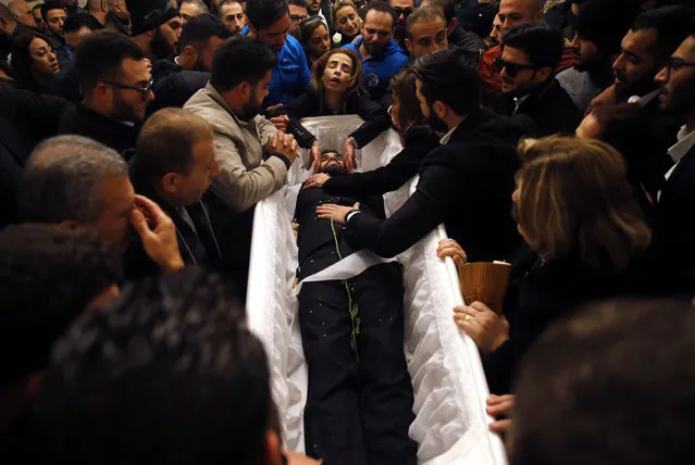 Relatives and friends of Elias Wardini, a Lebanese man who was killed in the New Year's Eve Istanbul nightclub attack, mourn over his coffin, at a church, in Beirut, Lebanon, Tuesday, January 3, 2017. (Photo by Hussein Malla/AP Photo)
