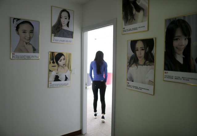 Online hostess Sun Xiaohou walks past portraits, into her broadcast room, in a building in Beijing April 1, 2015. (Photo by Jason Lee/Reuters)