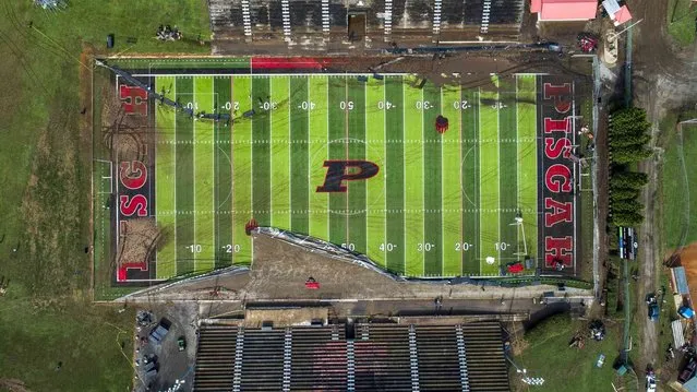 In this image taken with a drone, volunteers clear debris and try to salvage athletic equipment Thursday, August 19, 2021 at Pisgah High School in Canton, N.C., after remnants from Tropical Storm Fred caused flooding in parts of Western North Carolina Tuesday. (Photo by Travis Long/The News & Observer via AP Photo)