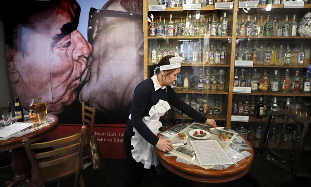 A waiter cleans the table in the buffet at the Vodka Museum in Moscow, Russia, 11 February 2019. The Vodka Museum founded in 2001 with a collection showing the 500-year history of Russian vodka from the moment of invention to the present day, the museum contains more than 600 types of this drink, old vodka recipes of the 18th century, posters, photographs, and documents of different time periods. (Photo by Yuri Kochetkov/Reuters)