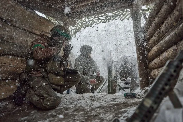 Mortar platoon soldiers with an 82mm mortar perform a combat mission as Ukrainian soldiers hold their positions in the snow-covered Serebryan Forest in temperatures of –15°C, on January 10, 2024 in Kreminna, Ukraine. Ukraine's Azov National Guard Brigade has returned to the front and has engaged in combat in the ongoing war with Russia. In 2022, Azov Brigade had fought in the battle of Mariupol and siege of the Azovstal Iron and Steel Works before some commanders were taken as prisoners of war and later released through Turkey. (Photo by Kostiantyn Liberov/Libkos/Getty Images)