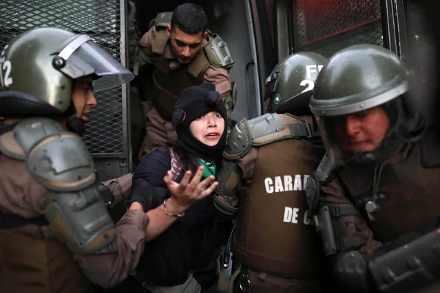A demonstrator is detained by riot police during a rally against presidents who attend the Prosur summit of South American leaders, in Santiago, Chile, March 22, 2019. (Photo by Pablo Sanhueza/Reuters)