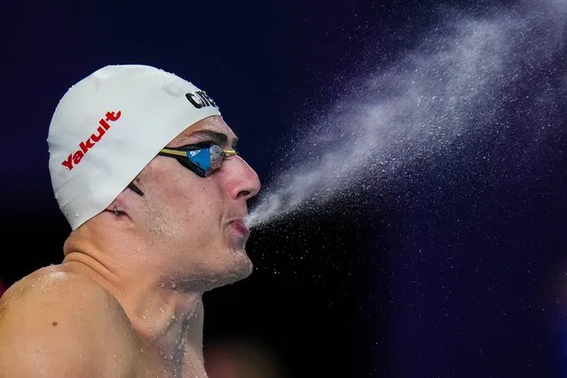 Arkadios Aspougalis of Greece sprays water as he prepares to compete in the mixed 4x100m medley heat at the World Aquatics Championships in Doha, Qatar, Wednesday, February 14, 2024. (Photo by Hassan Ammar/AP Photo)