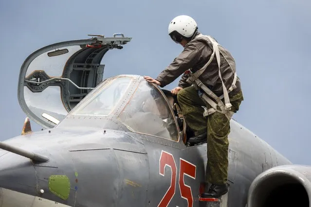 A Russian pilot gets inside a Sukhoi Su-25 fighter jet before the take-off, part of the withdrawal of Russian troops from Syria, at Hmeymim airbase, Syria, March 16, 2016. (Photo by Vadim Grishankin/Reuters/Russian Ministry of Defence)