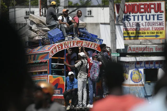Commuters ride a Tap Tap bus in Port-au-Prince, Haiti, Wednesday, October 20, 2021. (Photo by Matias Delacroix/AP Photo)