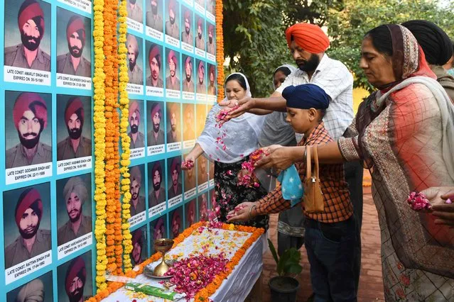 Relatives of slain Punjab Police personnel pay tribute to their lost one during an event to mark Police Commemoration Day at a police station on the outskirts of Amritsar on October 21, 2021. (Photo by Narinder Nanu/AFP Photo)