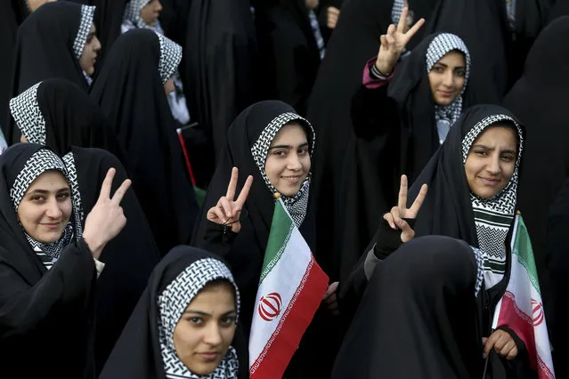 Iranian school girls flash the victory sign during an annual rally commemorating the anniversary of the 1979 Islamic revolution, which toppled the late pro-U.S. Shah, Mohammad Reza Pahlavi, in Tehran, Iran, Friday, February 10, 2017. (Photo by Ebrahim Noroozi/AP Photo)