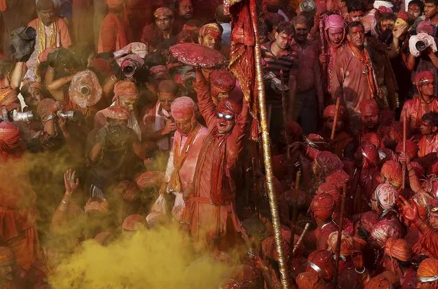 Hindu devotees take part in the religious festival of Holi, also known as the festival of colours, in the Nandgaon temple in Mathura in the Uttar Pradesh region of India, March 18, 2016. (Photo by Anindito Mukherjee/Reuters)