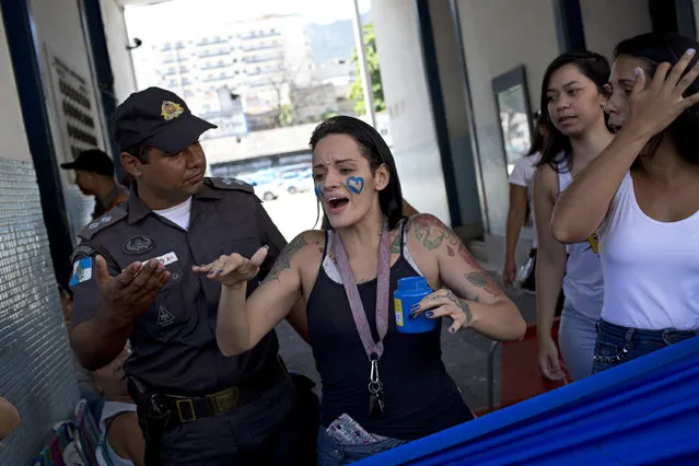 Relatives of military police members block an entrance in an attempt to impede officers from going to work at a military police in Rio de Janeiro, Brazil, Friday, February 10, 2017. The family members are demanding better salaries and labor conditions and they block the exits not allowing the officers to go work. Brazil's military police force patrols the nation's cities and its members are barred by law from going on strike. (Photo by Silvia Izquierdo/AP Photo)