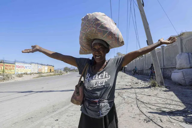 A woman shouts out how her family died during gang violence as she flees her home in Cite Soleil and walks to a police station with other displaced people, in Port-au-Prince, Haiti, Monday, February 12, 2024. (Photo by Odelyn Joseph/AP Photo)