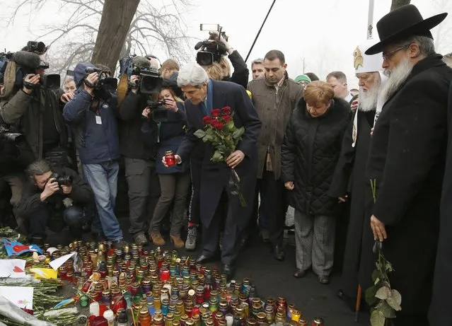 Secretary of State John Kerry places a candle and roses atop the Shrine of the Fallen in Kiev, Ukraine, Tuesday, March 4, 2014. The Shrine of the Fallen, located on Institutska Street, honors the fallen Heroes of the “Heavenly Sotnya” (Hundred). Over the course of the EuroMaidan protests, almost 100 protesters were killed by police. (Photo by Kevin Lamarque/AP Photo)