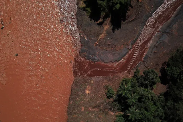 Mud reaches the Paraopeba river in Brumadinho, Minas Gerais state, Brazil on March 18, 2019, after the collapse of a dam at an iron-ore mine belonging to Brazil's giant mining company Vale on January 25, 2019. Two months after an upstream tailings dam, owned by mining giant Vale burst, spewed millions of tons of minerals-laced sludge across the countryside, Vale, government agencies and environmental groups are still assessing the impact of Brazil's worst industrial disaster on water quality downstream. (Photo by Douglas Magno/AFP Photo)