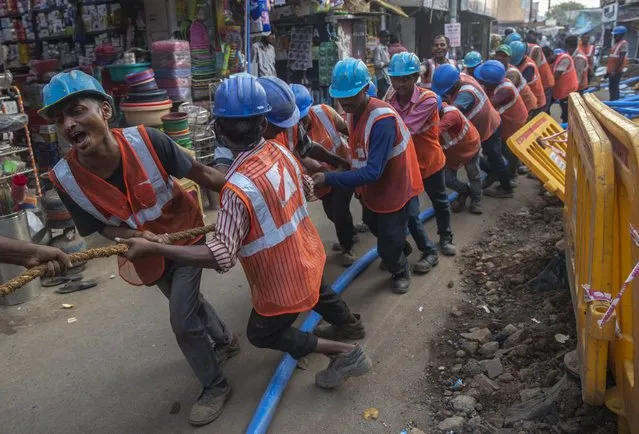 Workers prepare work to lay an underground electricity cable in Mumbai, India Wednesday, November 24, 2021. India’s economy grew by 8.4% in the July-September quarter from the same period a year earlier, the government announced Tuesday, signaling hopes of a growing economic recovery after it suffered historic contractions sparked by the COVID-19 pandemic. (Photo by Rafiq Maqbool/AP Photo)
