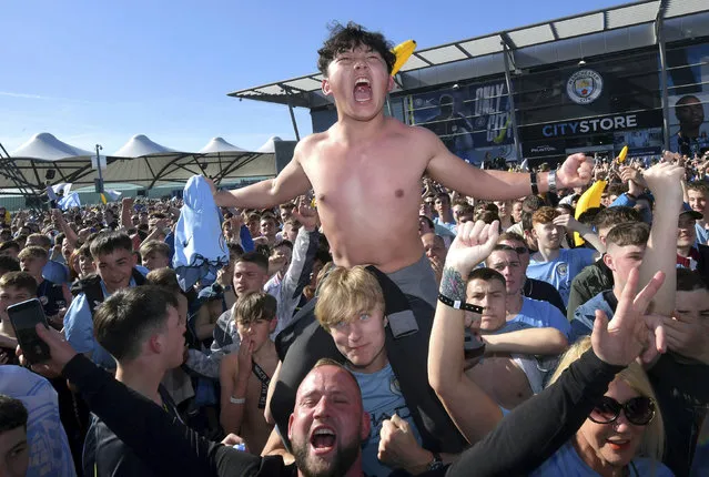 Manchester City fans celebrate as Manchester City win the premier league, at the Etihad Stadium, Manchester, England, Sunday, May 12, 2019. (Photo by Anthony Devlin/PA Wire via AP Photo)