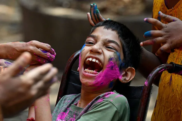 A special abled boy reacts during celebrations of the Hindu spring festival of “Holi” at a school for children with special needs in Mumbai on March 22, 2024. (Photo by Indranil Mukherjee/AFP Photo)
