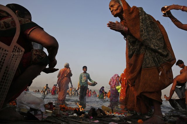 An elderly Indian Hindu devotee performs morning rituals on the banks of the Ganges River on the first day of the nine-day Hindu festival of Navratri, in Allahabad, India, Friday, April 8, 2016. Navaratri lasts for nine days, with three days each devoted to the worship of the goddess of valor Durga, the goddess of wealth Lakshmi, and the goddess of knowledge Saraswati. (Photo by Rajesh Kumar Singh/AP Photo)