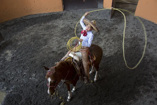 Diego Salamanca, 13, practices his lasso skills at the Rancho del Charro on the outskirts of Mexico City, Mexico, Saturday, May 18, 2019. Mexico's Charros National Association is marking their 98th anniversary, celebrated from May 15 -June 2. (Photo by Ginnette Riquelme/AP Photo)