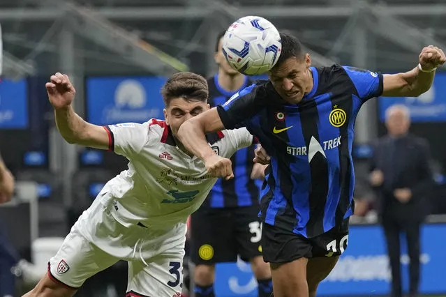 Inter Milan's Alexis Sanchez, right, heads the ball during the Italian Serie A soccer match between Inter Milan and Cagliari at the San Siro stadium in Milan, Italy, Sunday, April 14, 2024. (Photo by Antonio Calanni/AP Photo)