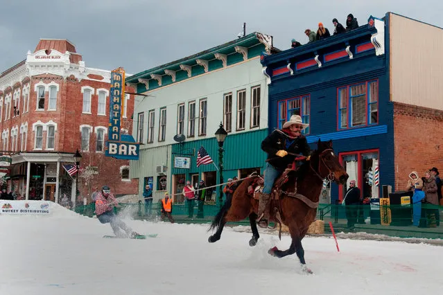 Rider Jeff Dahl races down Harrison Avenue towing skier and son Jason Dahl during the 68 th annual Leadville Ski Joring weekend competition on March 5, 2017 in Leadville, Colorado. Skijoring, which has its origins as a competitive sport in Scandinavia, has been adapted over the years to include a team made up of a rider and skier who must navigate jumps, slalom gates, and the spearing of rings for points. Leadville, with an elevation of 10,152 feet (3,094 m), the highest incorporated city in North America, has been hosting skijoring competitions since 1949. (Photo by Jason Connolly/AFP Photo)