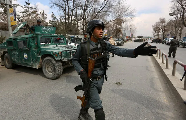 Security forces inspect the site of attack on a military hospital in Kabul, Afghanistan, Wednesday, March 8, 2017. Gunmen stormed the military hospital Wednesday in a neighborhood in the Afghan capital that is also home to a number of embassies. (Photo by Rahmat Gul/AP Photo)