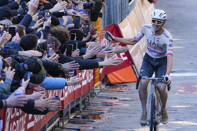 Winner Slovenia's Tadej Pogacar celebrates before crossing the finish line during the men's Strade Bianche' (White Roads) cycling race from and to Siena, Italy, Saturday, March 2, 2024. (Photo by Gian Mattia D'Alberto/LaPresse via AP Photo)