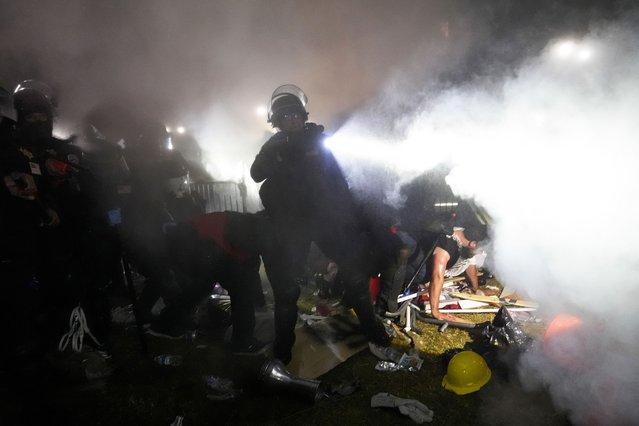 Police enter an encampment set up by pro-Palestinian demonstrators on the University of California, Los Angeles campus Thursday, May 2, 2024, in Los Angeles. (Photo by Jae C. Hong/AP Photo)
