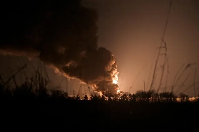 A view shows a burning oil depot reportedly hit by shelling near the military airbase Vasylkiv in the Kyiv region, Ukraine on February 27, 2022. (Photo by Maksim Levin/Reuters)