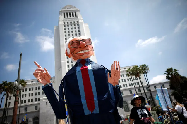People hold a puppet of U.S. Democratic presidential candidate Bernie Sanders as they protest against fracking and neighborhood oil drilling in Los Angeles, California, U.S., May 14, 2016. (Photo by Lucy Nicholson/Reuters)