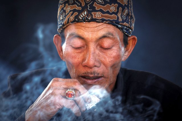 A Tenggerese Hindu shaman prays at Luhur Poten temple in Mount Bromo, during the Yadnya Kasada festival in Probolinggo, East Java, Indonesia, on June 21, 2024. The festival has been held by the Tenggerese since the 13th century to express their devotion and gratitude to their ancestors and gods, thousands of people trek to the top of Mount Bromo (2,329m) and end their ritual by hurling offerings into the volcano's crater. “To respond to what the Almighty has conveyed through nature, the people must adapt and they should not forget to pray”, said Suyitno, a Tenggerese spiritual leader. (Photo by Willy Kurniawan/Reuters)