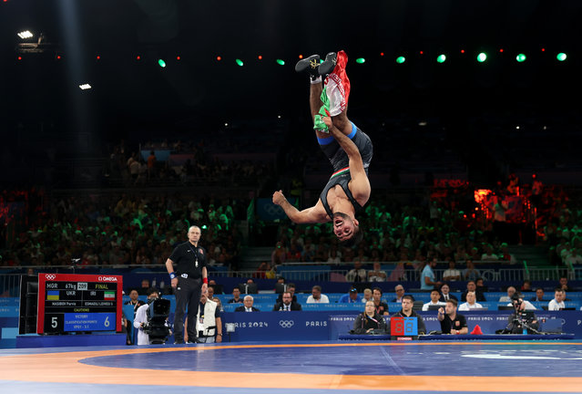 Saeid Esmaeili Leivesi of Team Islamic Republic Iran (blue) celebrates winning the gold medal after the Wrestling Men's Greco-Roman 67kg Final Match against Parviz Nasibov of Team Ukraine on day thirteen of the Olympic Games Paris 2024 at Champs-de-Mars Arena on August 08, 2024 in Paris, France. (Photo by Carl Recine/Getty Images)