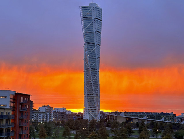 The sun sets behind the “Turning Torso” skyscraper in Malmoe, Sweden, Thursday, November 2, 2023. (Photo by Karl Ritter/AP Photo)