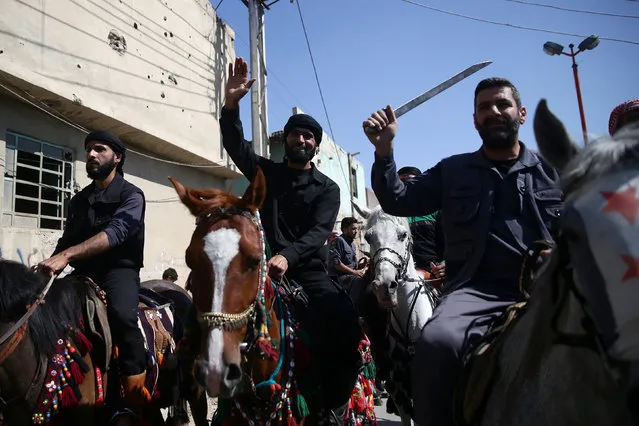 Men gesture as they ride horses during a parade for Arabian horses in the rebel held area of Damascus's Eastern Ghouta suburbs, Syria May 30, 2016. (Photo by Bassam Khabieh/Reuters)