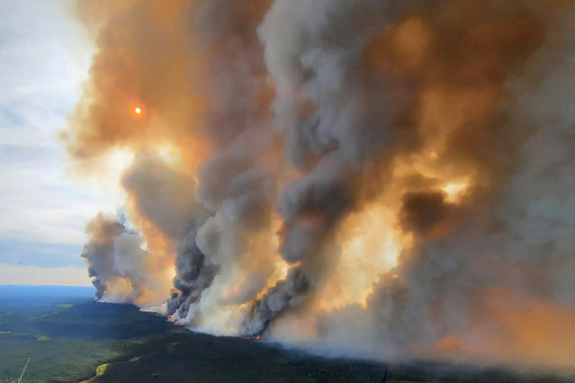 Smoke rises from a wildfire in the Donnie Creek Complex south of Fort Nelson, British Columbia, Canada on May 27, 2023. (Photo by B.C. Wildfire Service/Handout via Reuters)