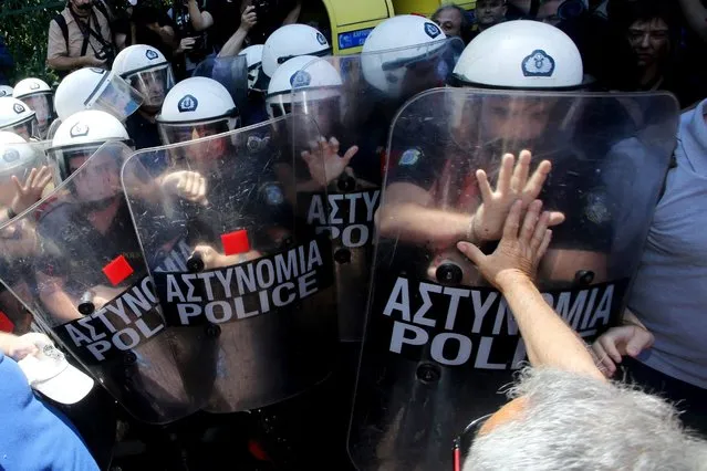 Greek striking medical personnel scuffle with riot police during a protest in central Athens, Greece, 08 June 2016. Demonstrators oppose cuts in the health system. (Photo by Pantelis Saitas/EPA)