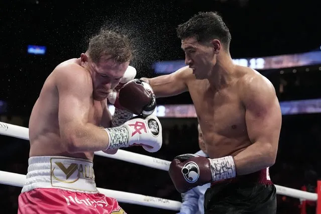 Dmitry Bivol, right, of Kyrgyzstan, throws a punch against Canelo Alvarez, of Mexico, during a light heavyweight title boxing match, Saturday, May 7, 2022, in Las Vegas. (Photo by John Locher/AP Photo)