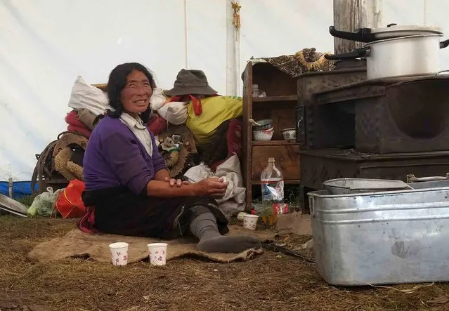 A Tibetan herdsman rests at her tent in Aba Tibetan and Quango Autonomous Prefecture, Sichuan province, August 1, 2015. (Photo by Natalie Thomas/Reuters)