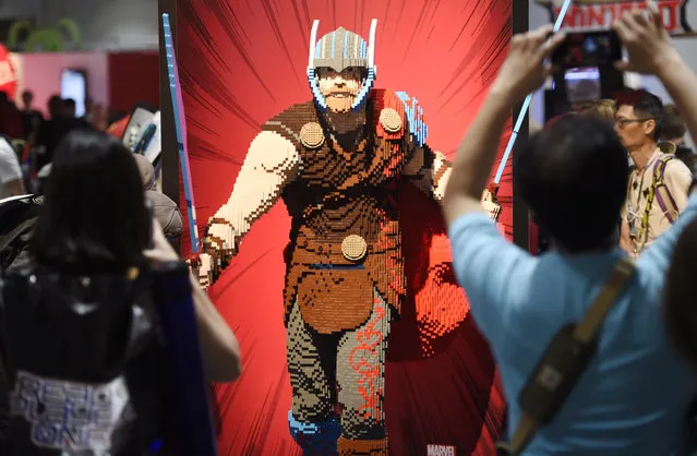 Comic-Con attendees photograph a life-size Lego statue of the superhero character Thor during Preview Night of the 2017 Comic-Con International on Wednesday, July 19, 2017, in San Diego, Calif. (Photo by Chris Pizzello/Invision/AP Photo)