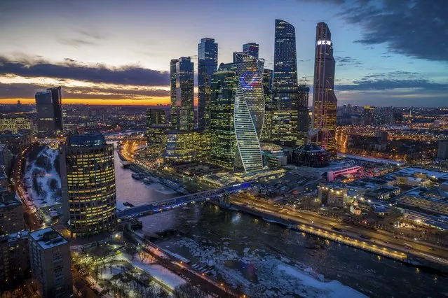 In this photo taken on Tuesday, February 19, 2019, The Moscow City skyscrapers are seen during a sunset in Moscow, Russia. (Photo by Dmitry Serebryakov/AP Photo)