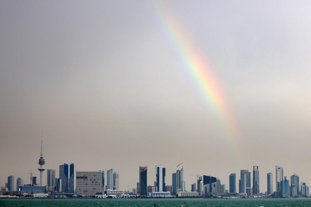 A rainbow is pictured after heavy rain above the skyline of Kuwait City on May 13, 2024. (Photo by Yasser Al-Zayyat/AFP Photo)